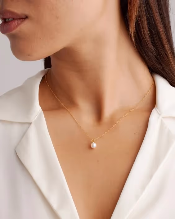Business Casual Dress Code for Client-Side Project Managers: a photo of a woman wearing a statement necklace.