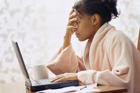 How to Call in Sick as a Project Manager: A photo of a Project Manager sending an email for a sick day.