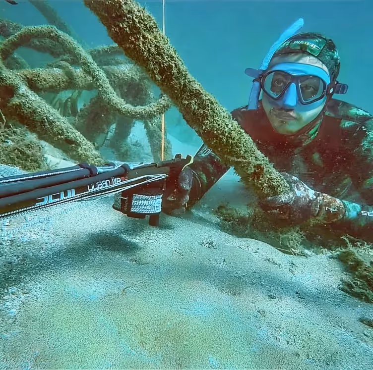Meet Ezzeddin, Our Team Member in Dubai, UAE: A diver spearfishing at the sea