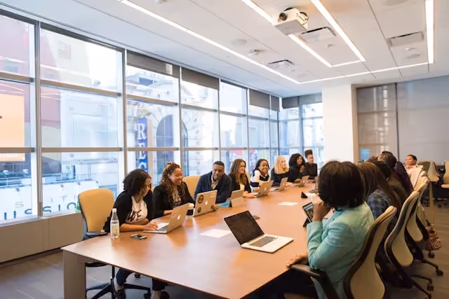 How to Prepare for a Successful PCG Meeting: A photo of a meeting with different members of a team inside a conference room.