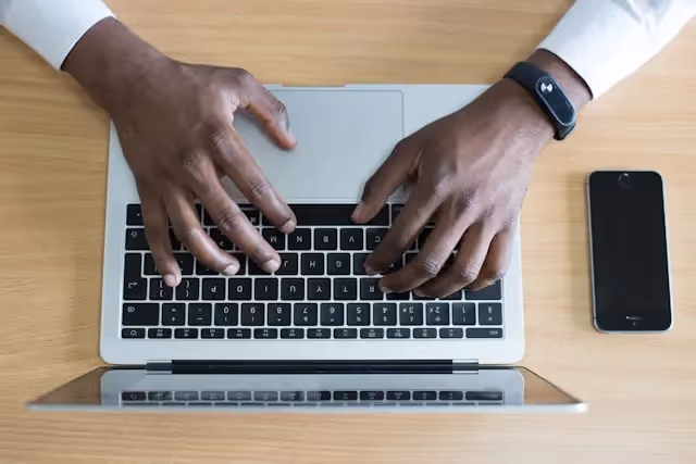 What to Include in a PCG Report: A photo of a person working in the laptop.
