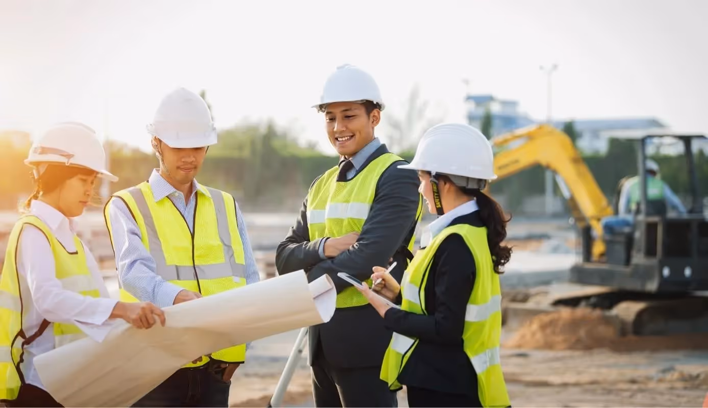 Project manager discussing plans with government representatives on a public-private partnership (PPP) project site.