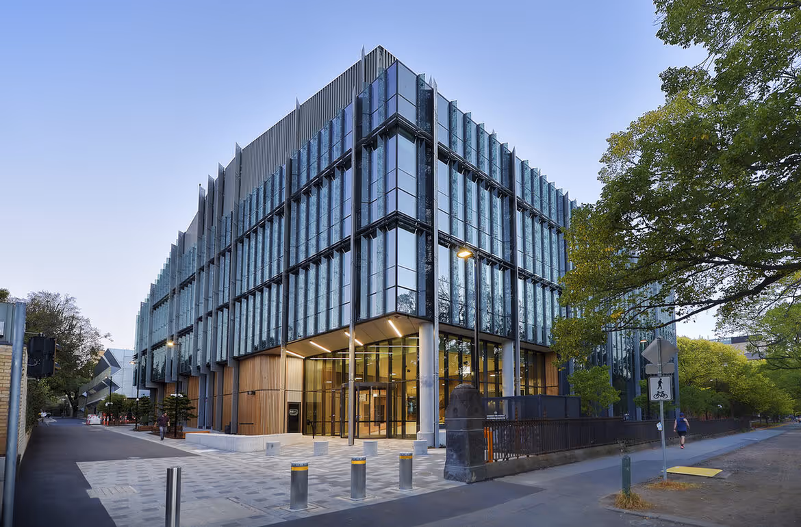 Exterior of the Western Edge Biosciences building with glass façade and modern vertical fins at the University of Melbourne.