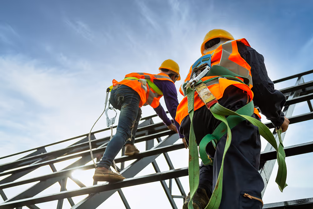  Workers on steel frame using SWMS safety controls.