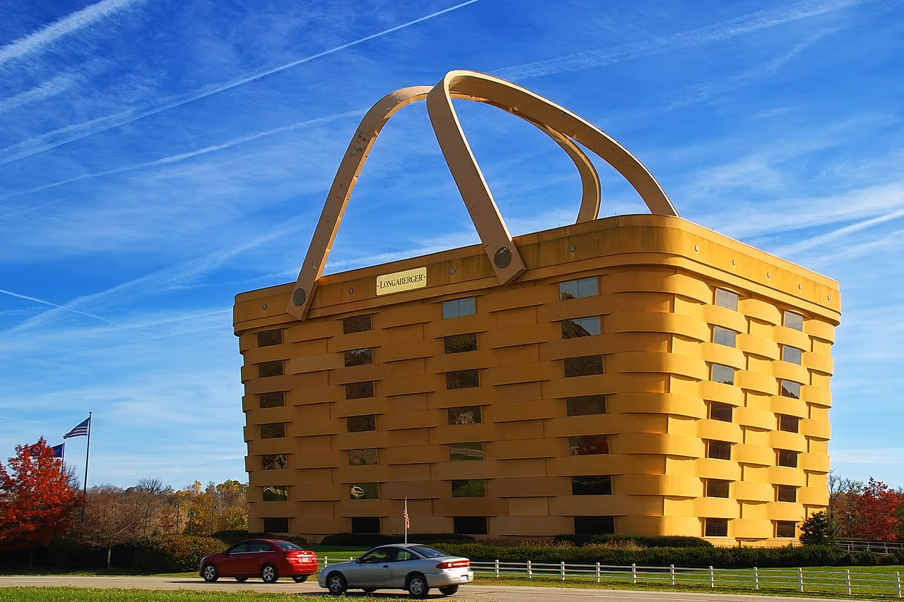 A seven-story office structure designed to resemble a giant woven picnic basket with two handles on top.