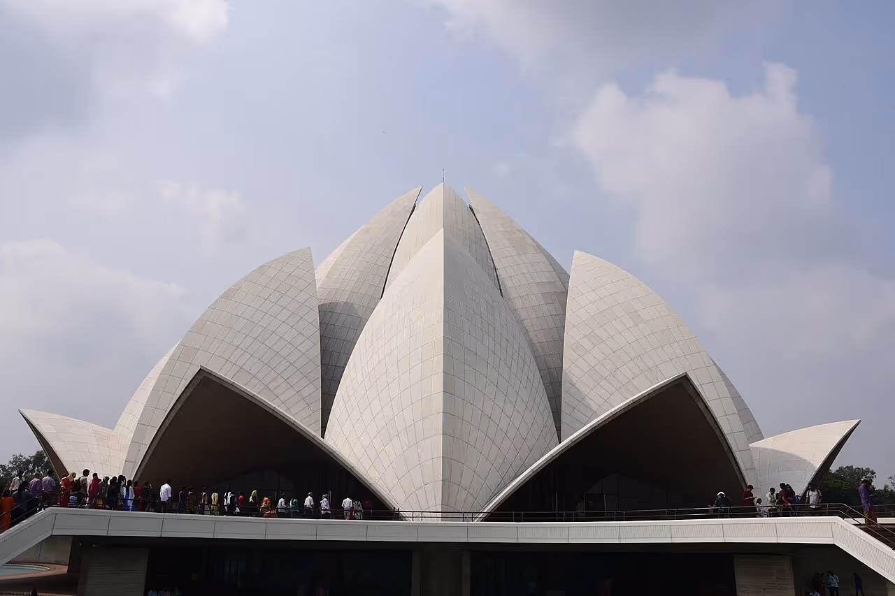 A Bahá’í House of Worship shaped like a blooming lotus flower with layered white marble petals.
