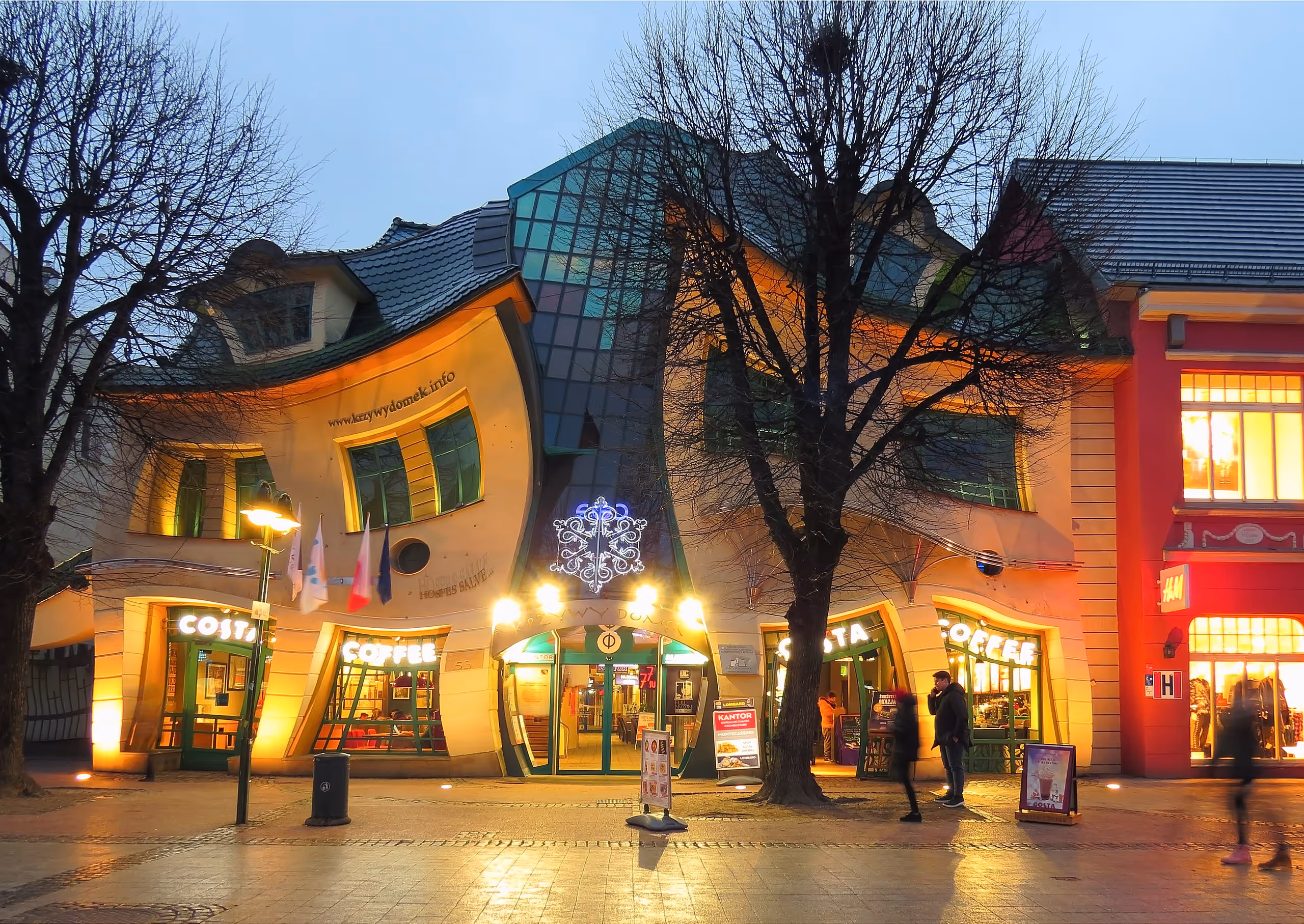 A distorted, whimsical commercial building with warped walls and roofs, resembling a cartoon house.