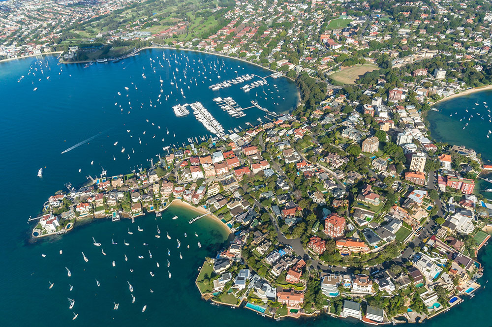 Aerial view shows property development in Australia waterfront suburb.