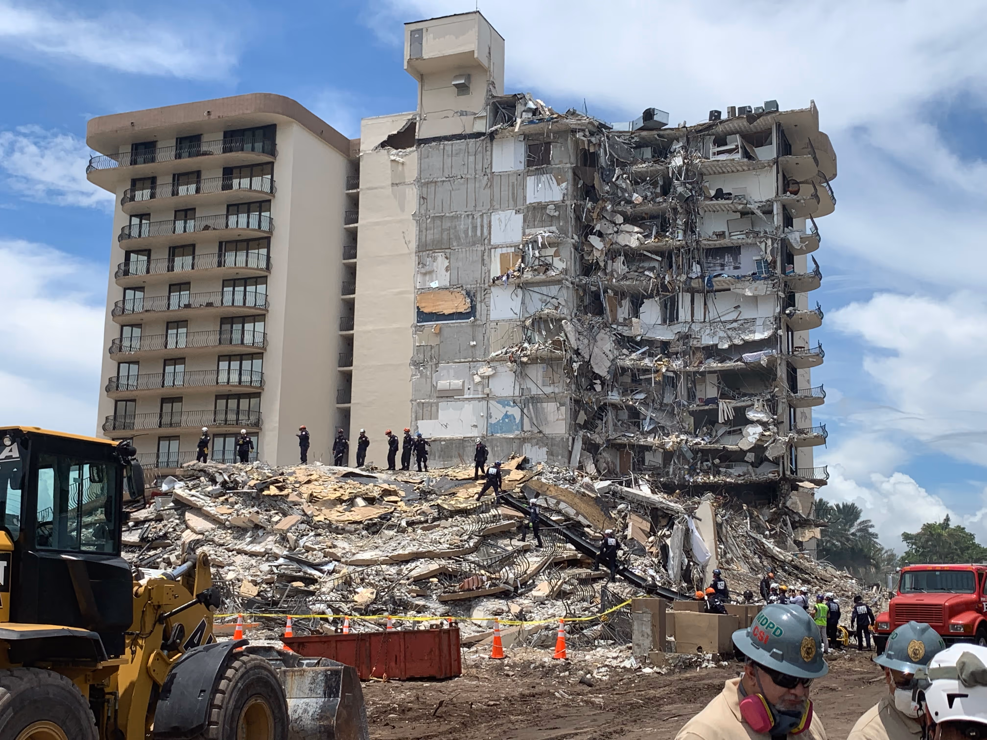 Wide view of Champlain Towers South showing exposed interior and debris during search-and-rescue operations.