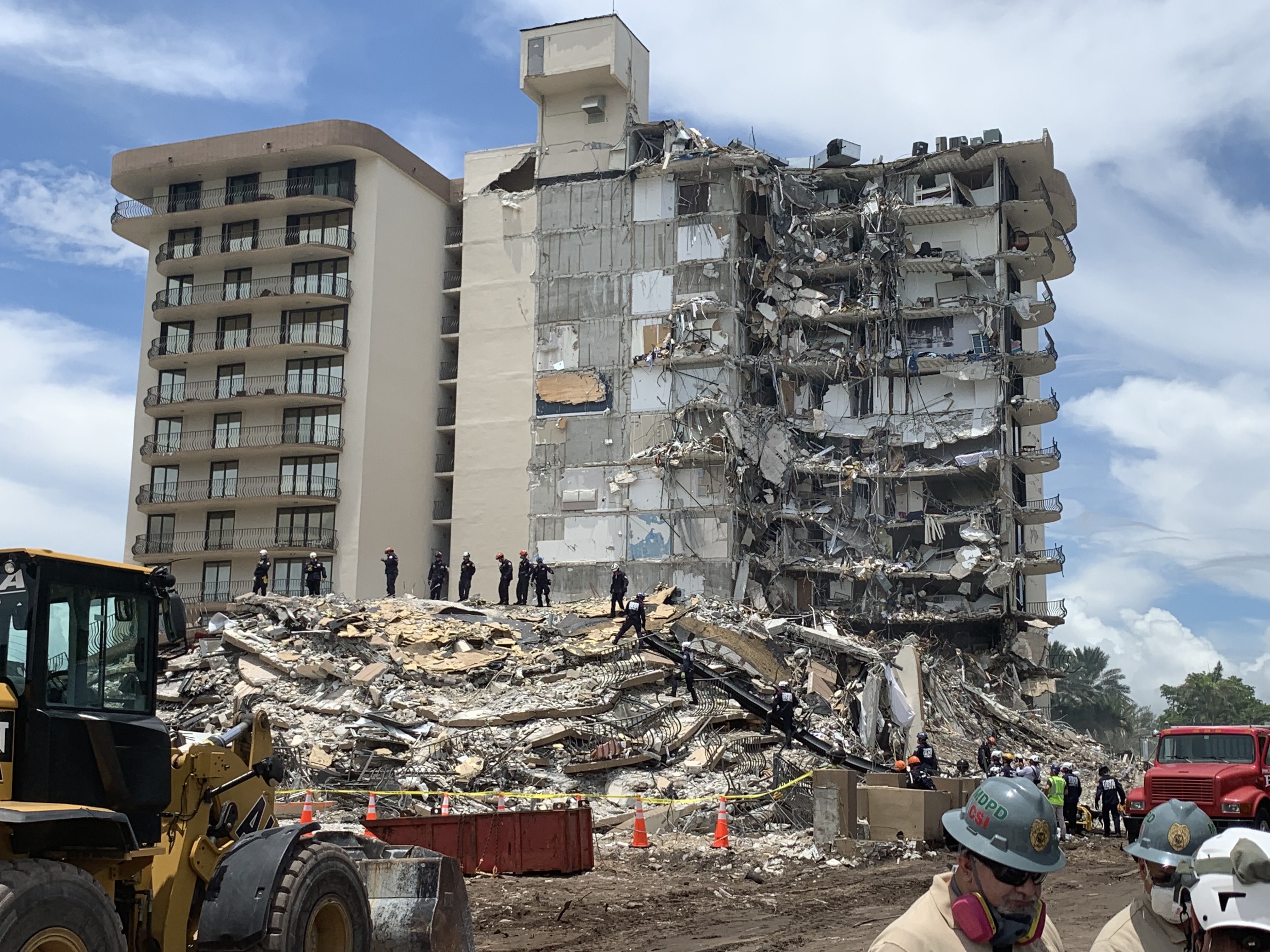 Wide view of Champlain Towers South showing exposed interior and debris during search-and-rescue operations.