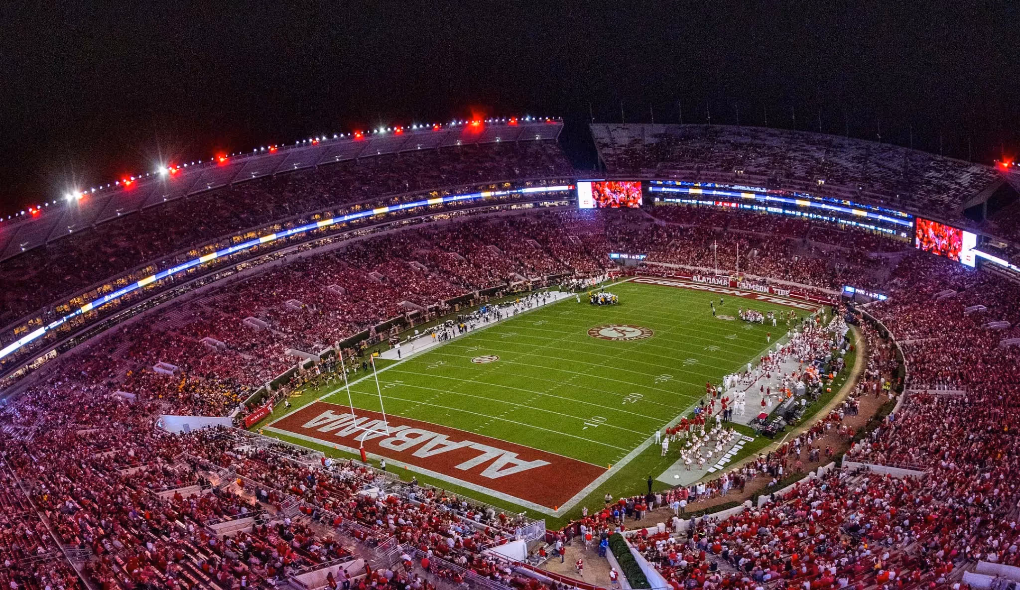 Bryant–Denny Stadium at night filled with Alabama fans