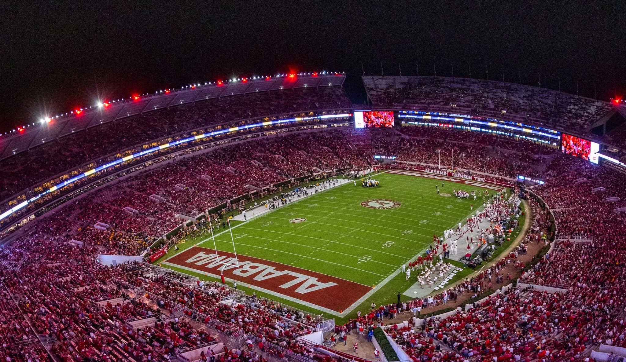 Bryant–Denny Stadium at night filled with Alabama fans