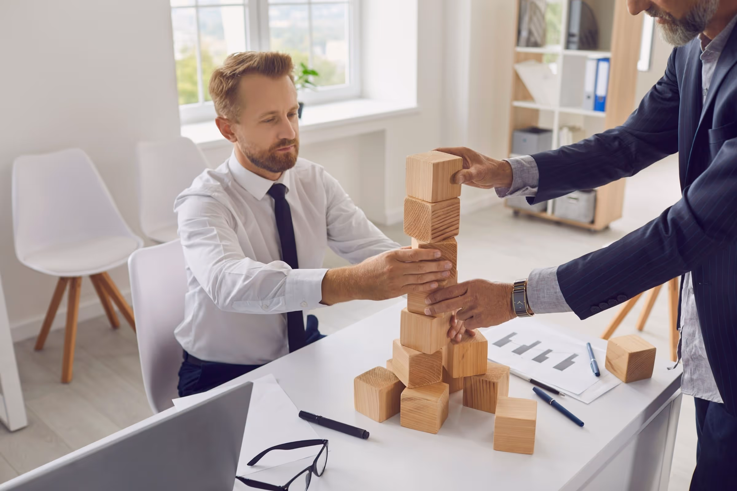 Commercial general contractors building with blocks to symbolize project delivery.