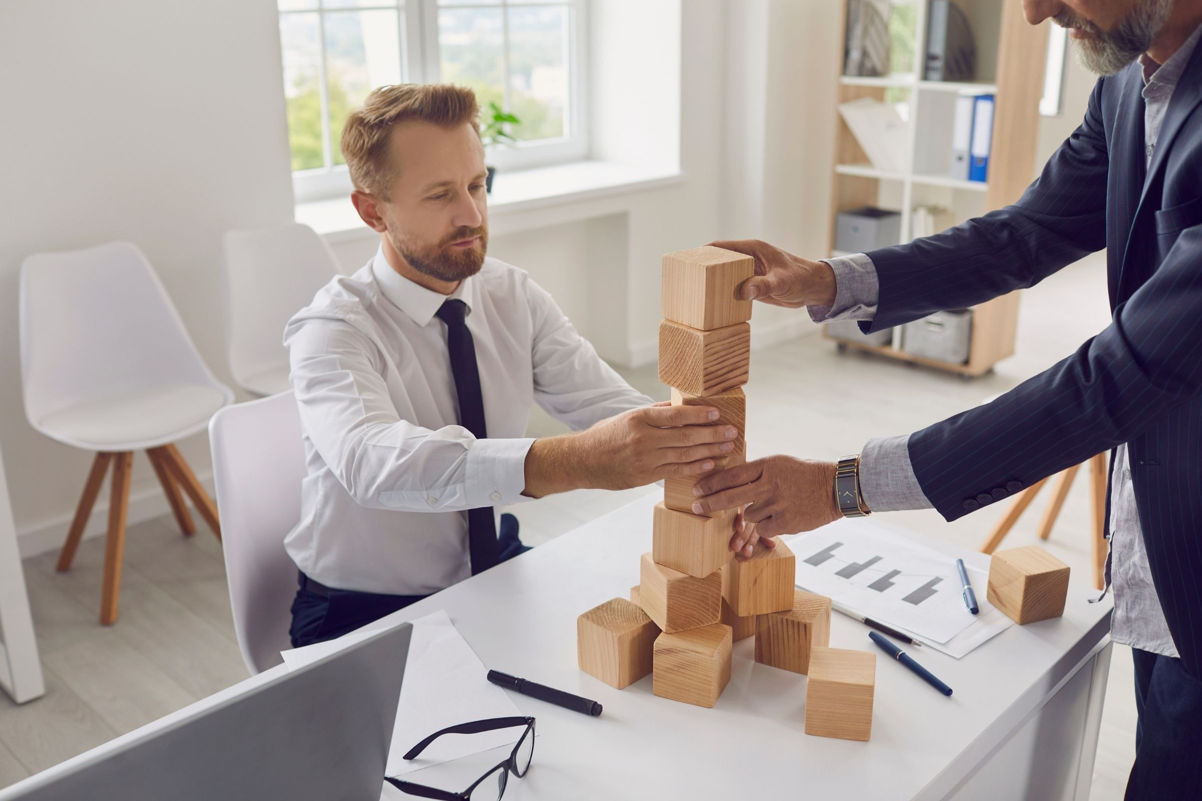 Commercial general contractors building with blocks to symbolize project delivery.