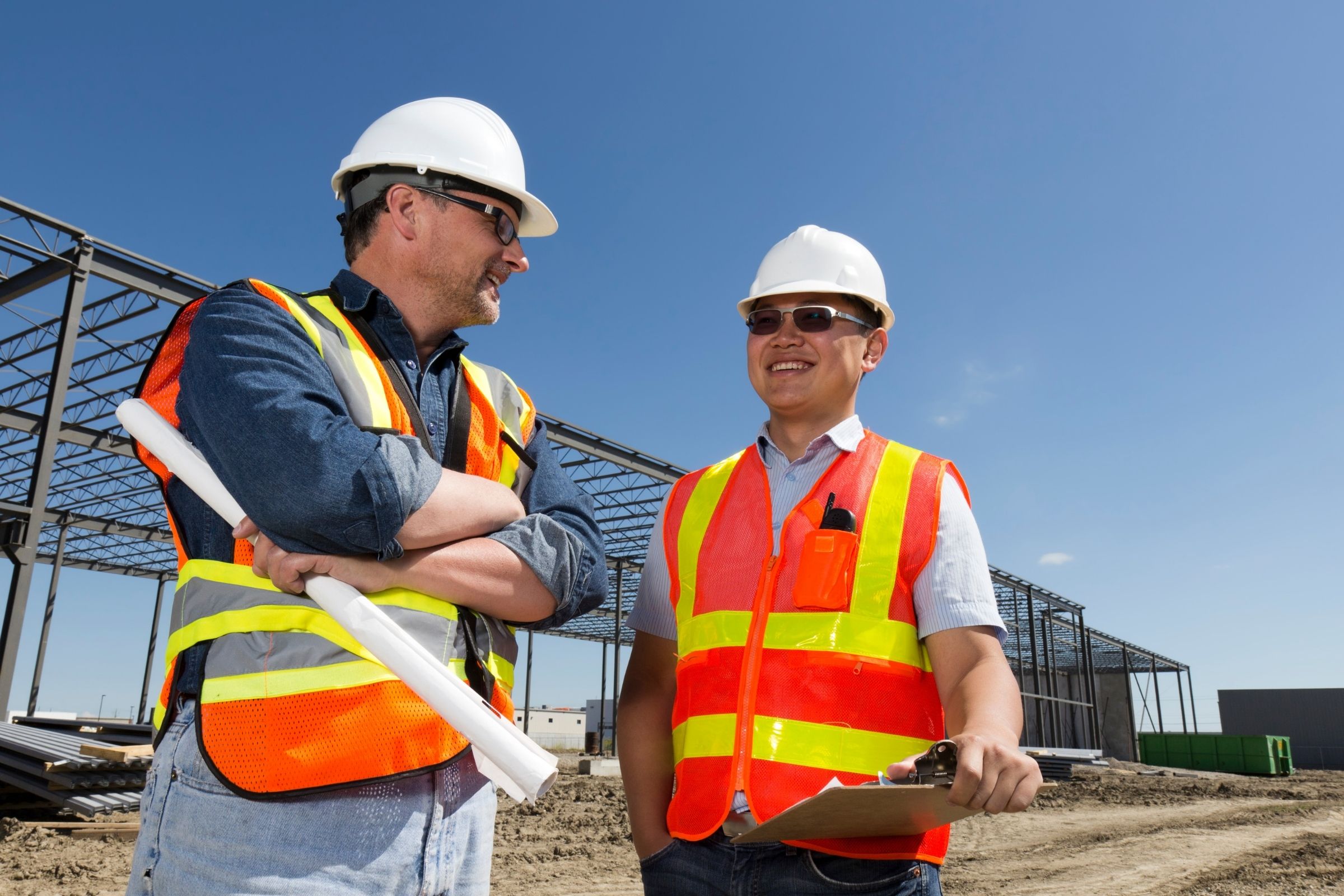 Commercial general contractors coordinating on active construction site.