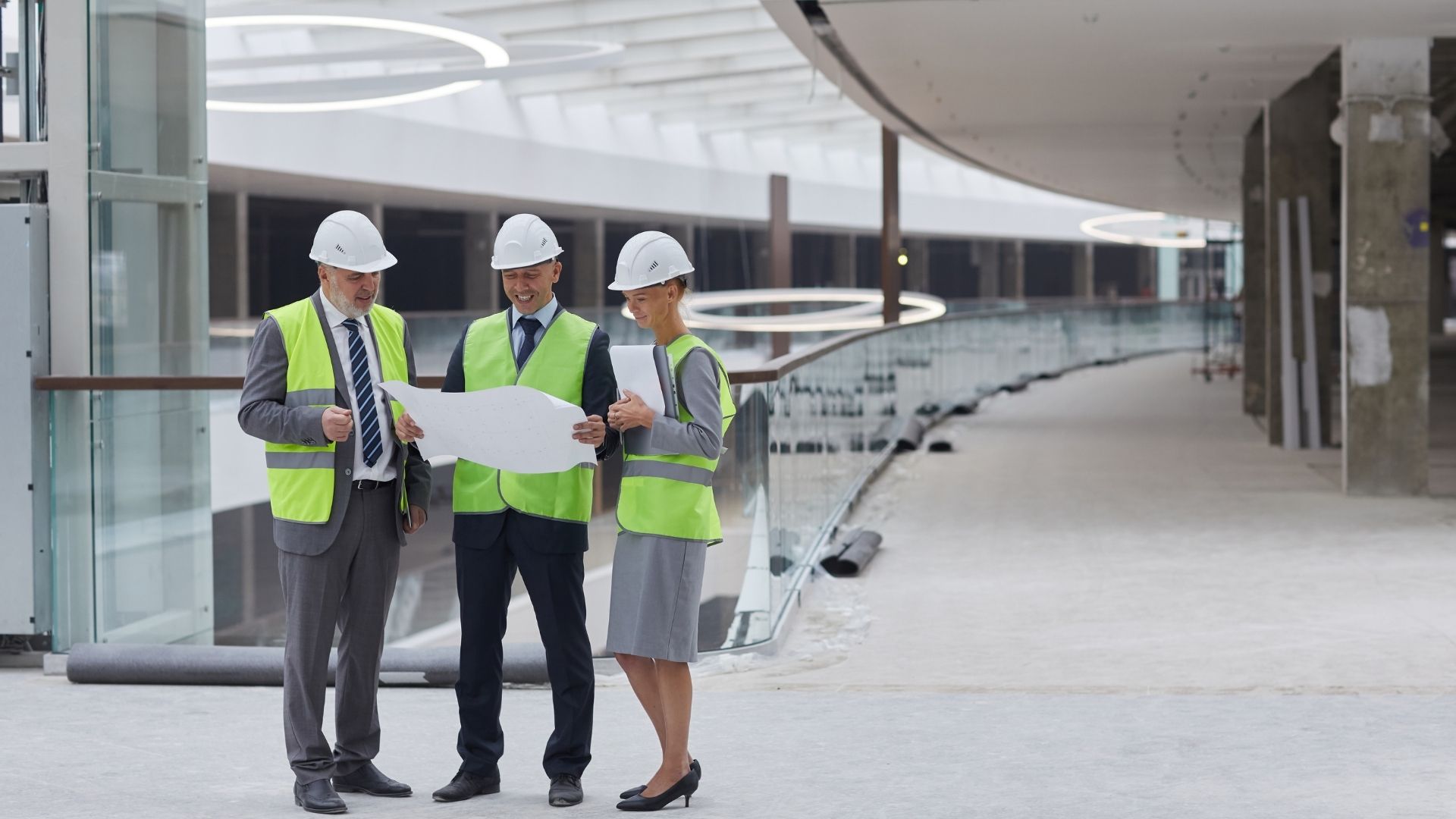 Commercial construction project management team reviewing site plans