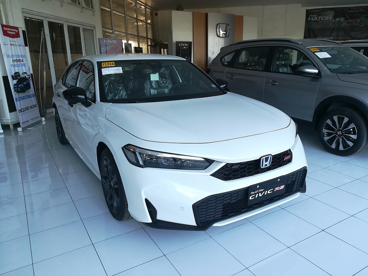 A 2026 Honda Civic in silver, three-quarter front view.