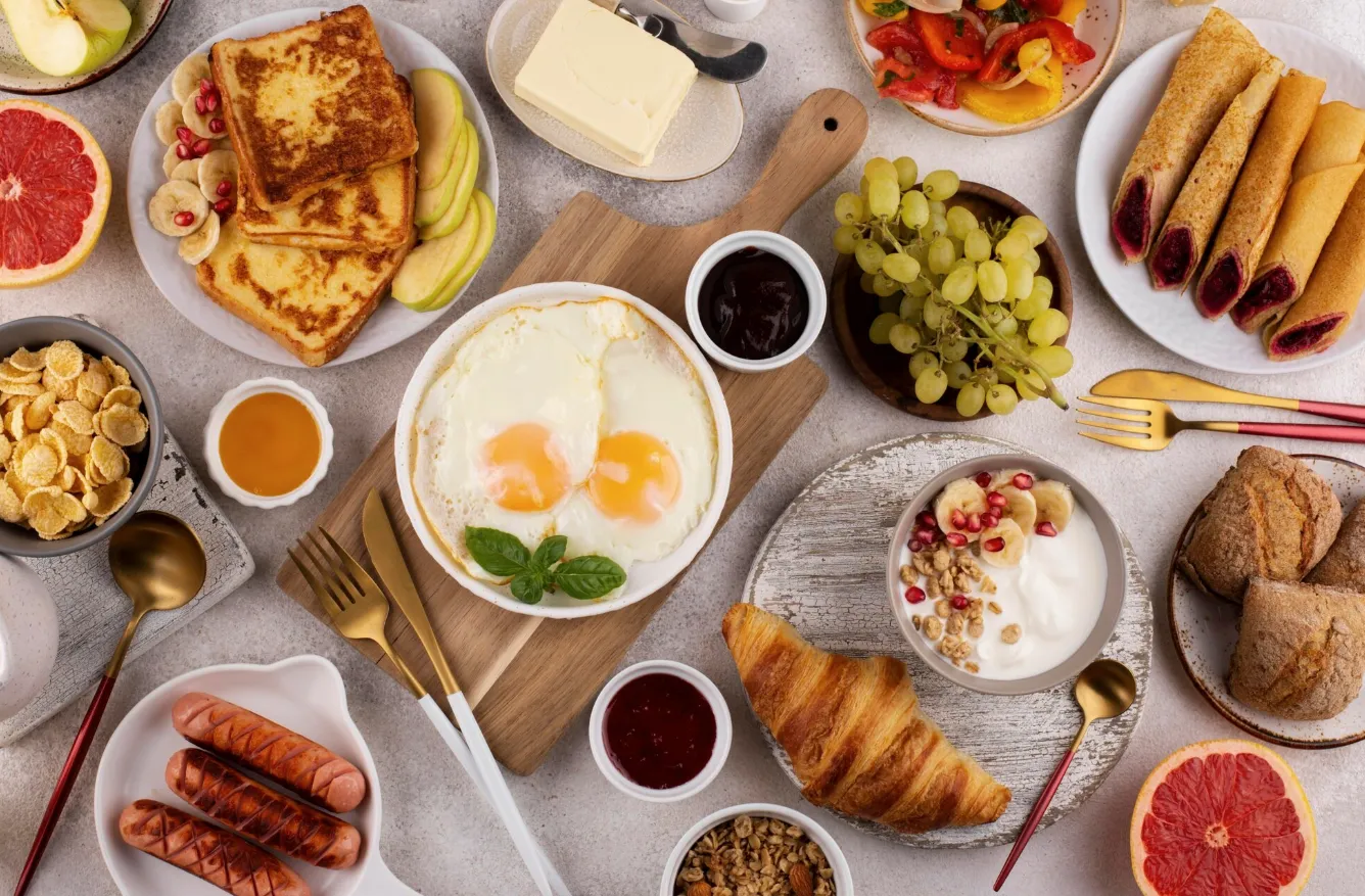 A table topped with plates of food and a drink
