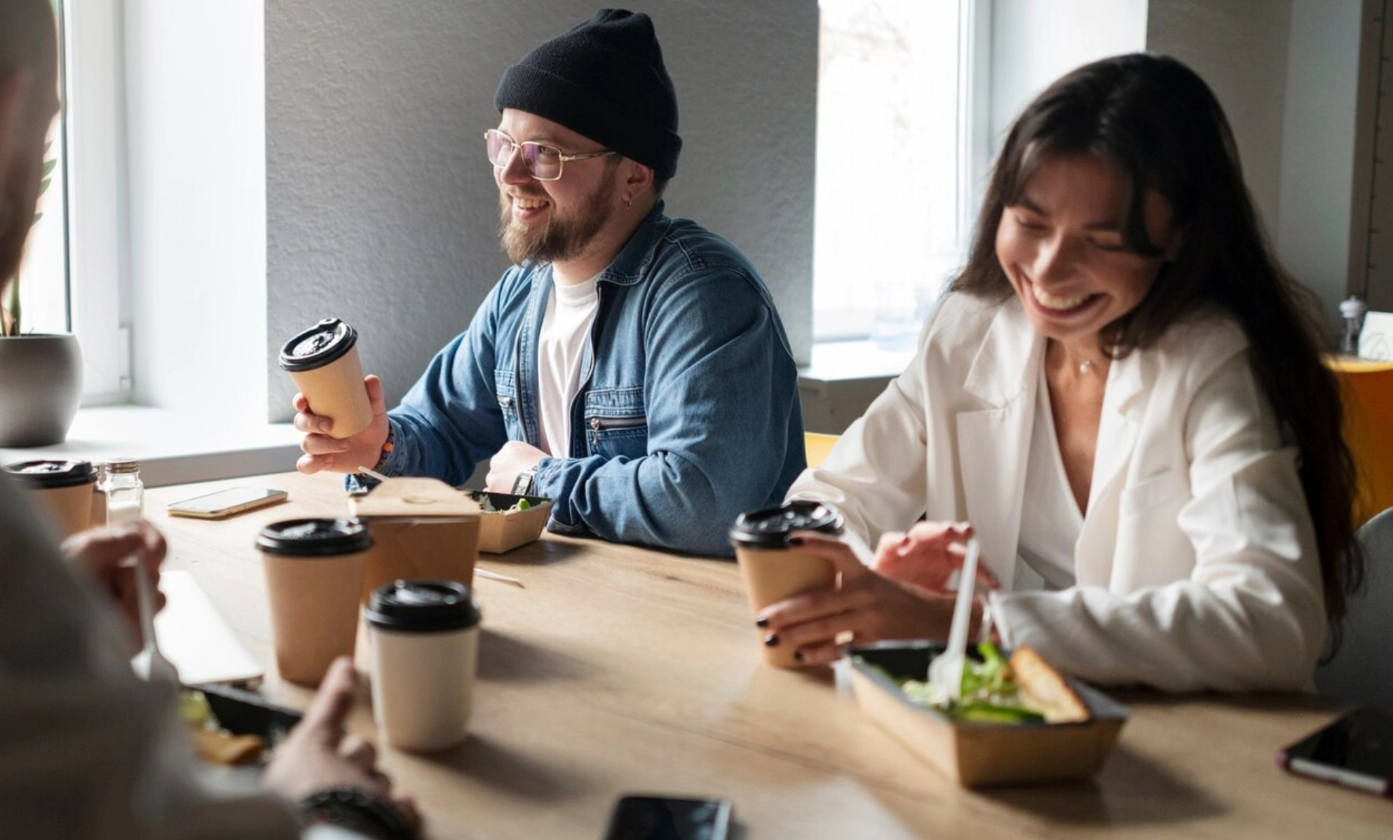 A man and woman eating at a table