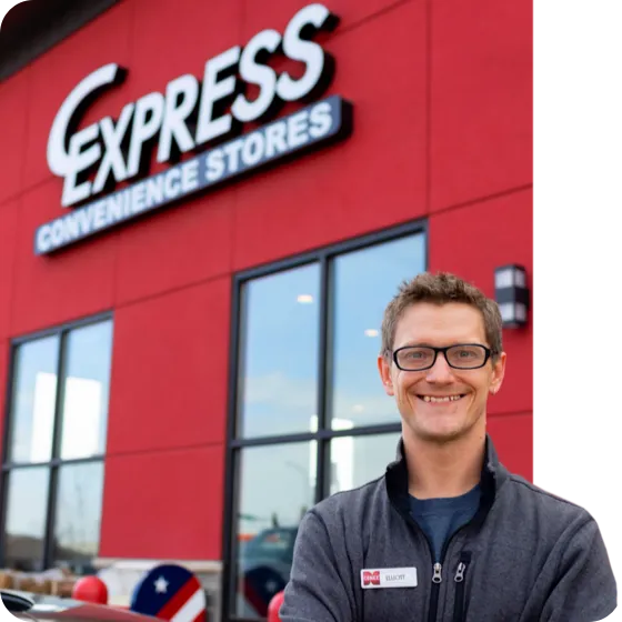 c-express employee standing in front of store sign