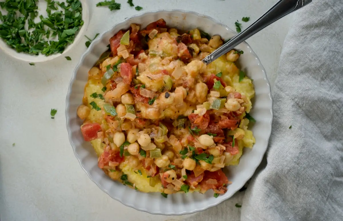 Bowl of vegetarian shrimp and grits with chickpeas.