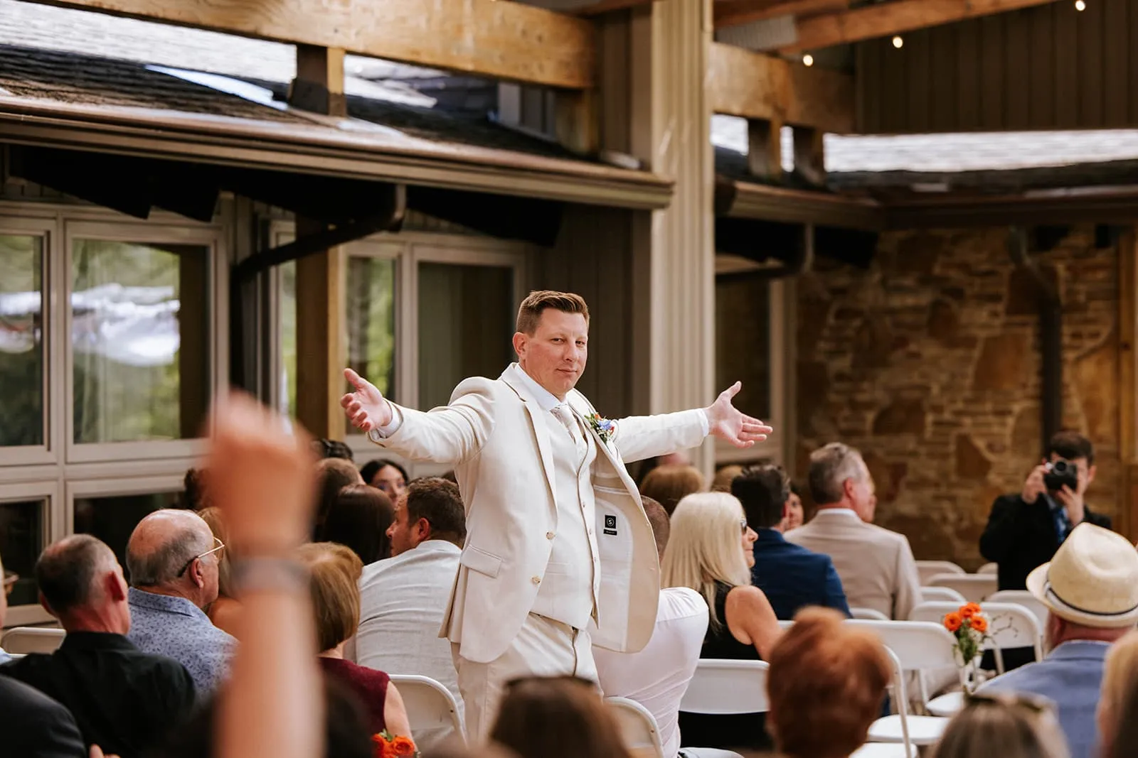 Groom celebrating during the outdoor wedding ceremony