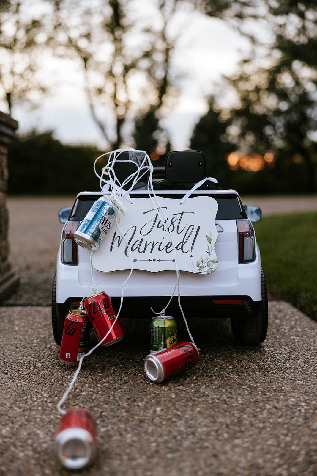 Just Married sign on a toy car with cans