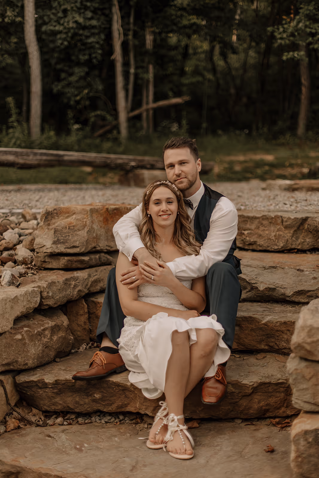 Seated bride and groom portrait on stone steps
