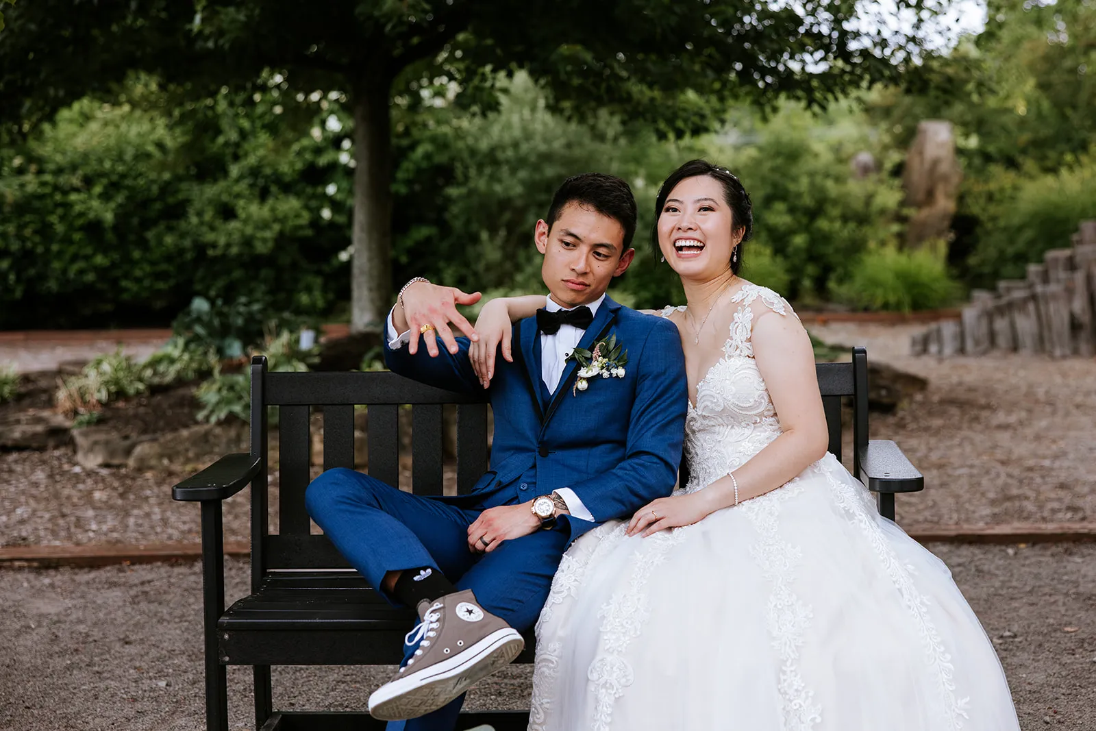Couple laughing together on a park bench