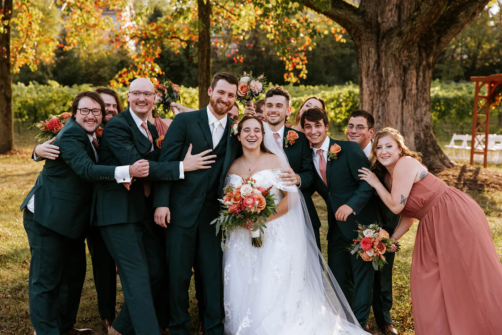 Wedding party group hug at the vineyard