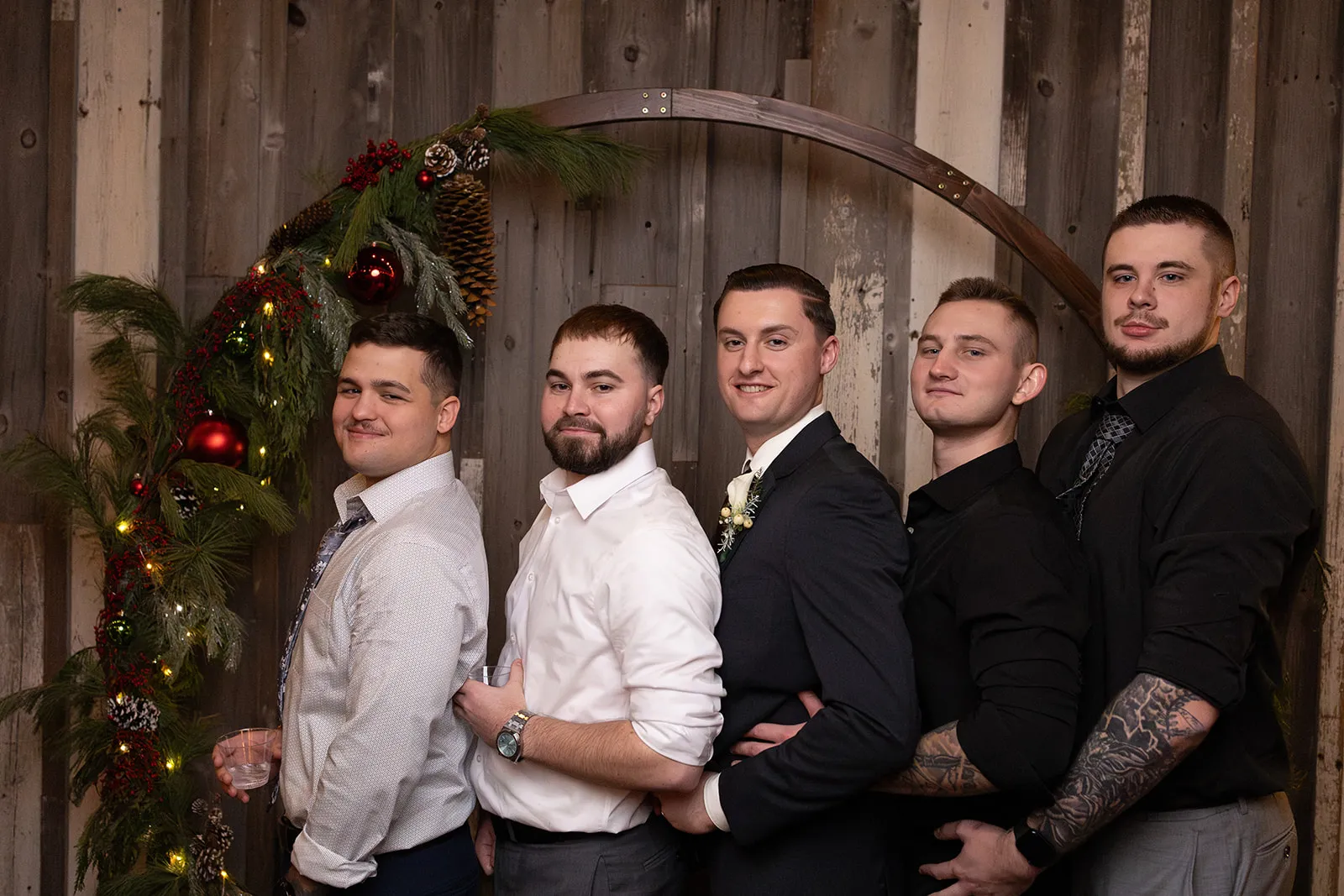 Groomsmen posing together in the Heirloom wedding photo booth