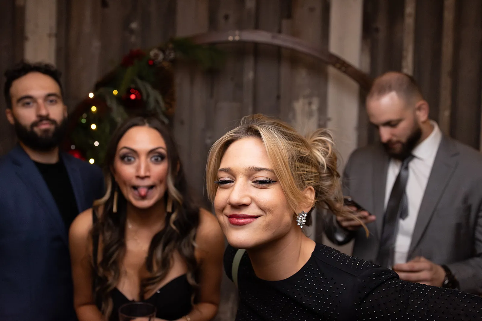 Two couples laughing together in the reception photo booth