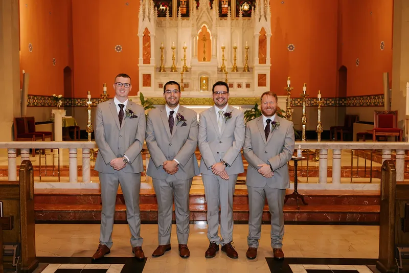 Groom and groomsmen in gray suits at the church.