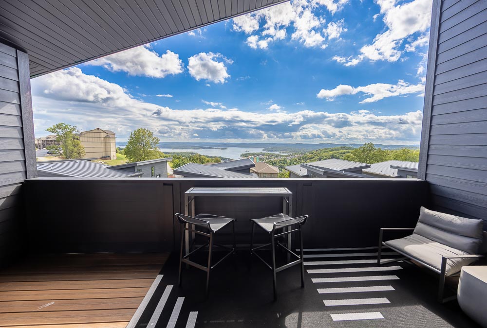 Private suite veranda with bistro seating and a lounge chair overlooking Table Rock Lake