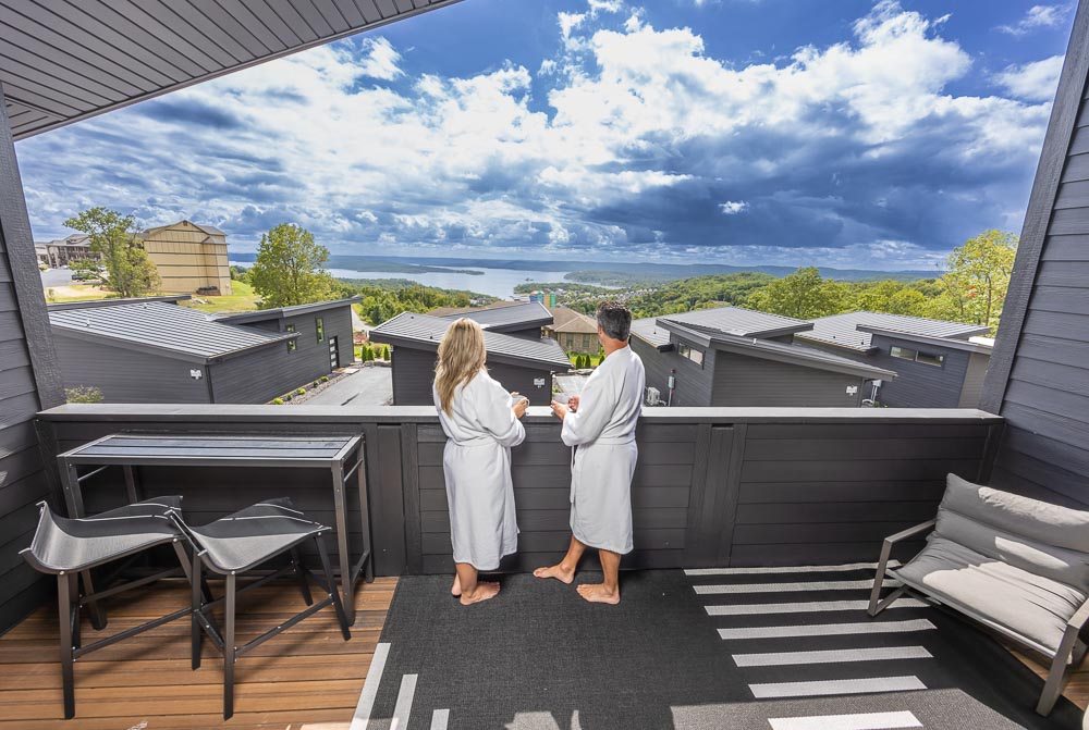 Couple in white robes on a suite veranda looking out over Table Rock Lake