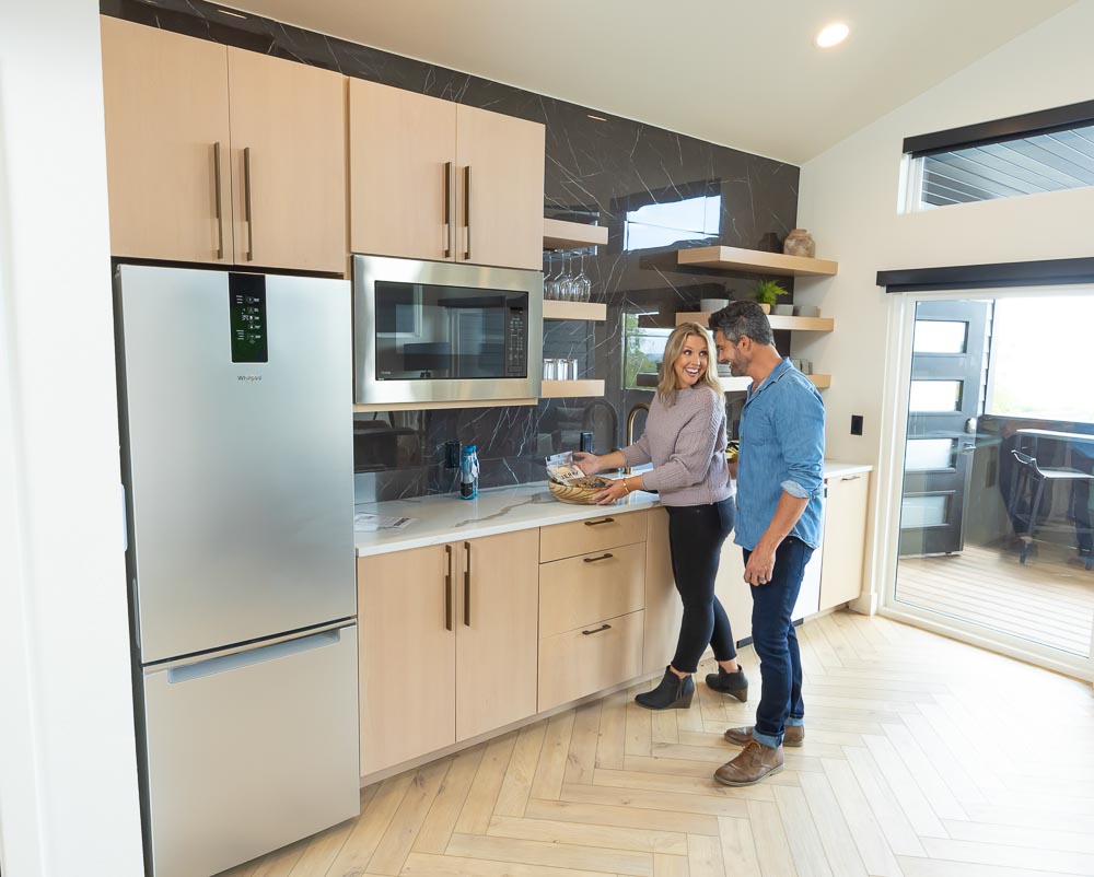 Couple preparing food together in a suite kitchenette