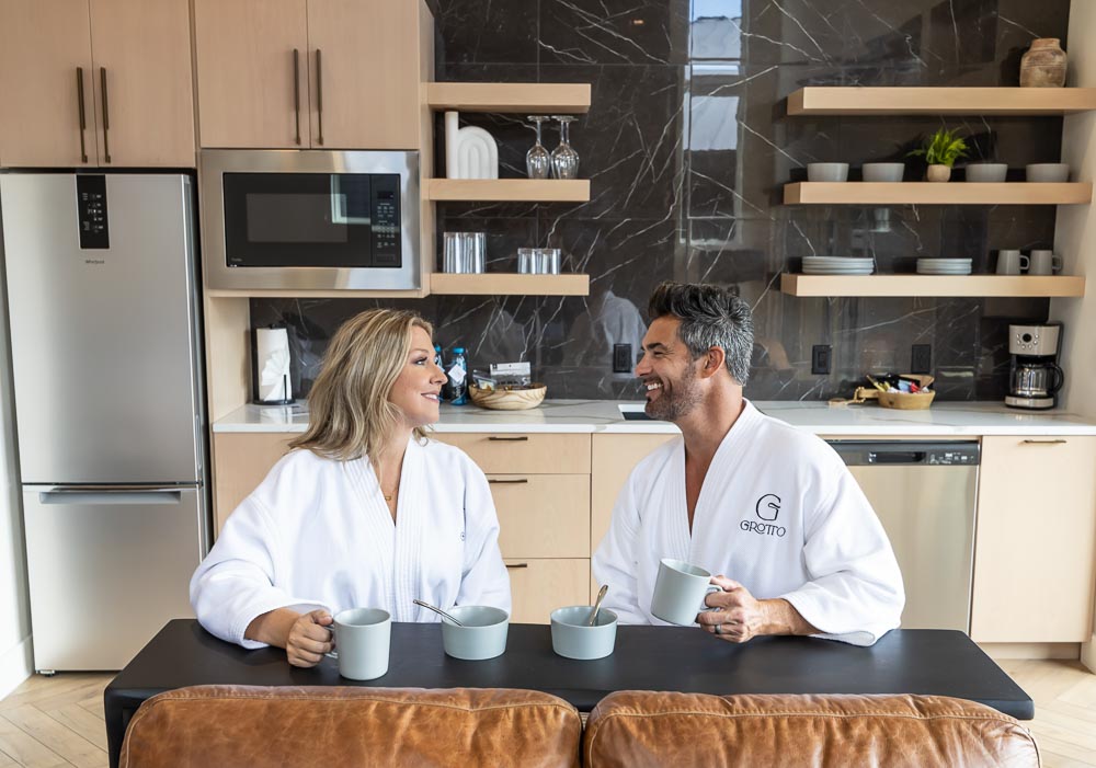 Couple in Grotto robes having coffee at the kitchenette counter