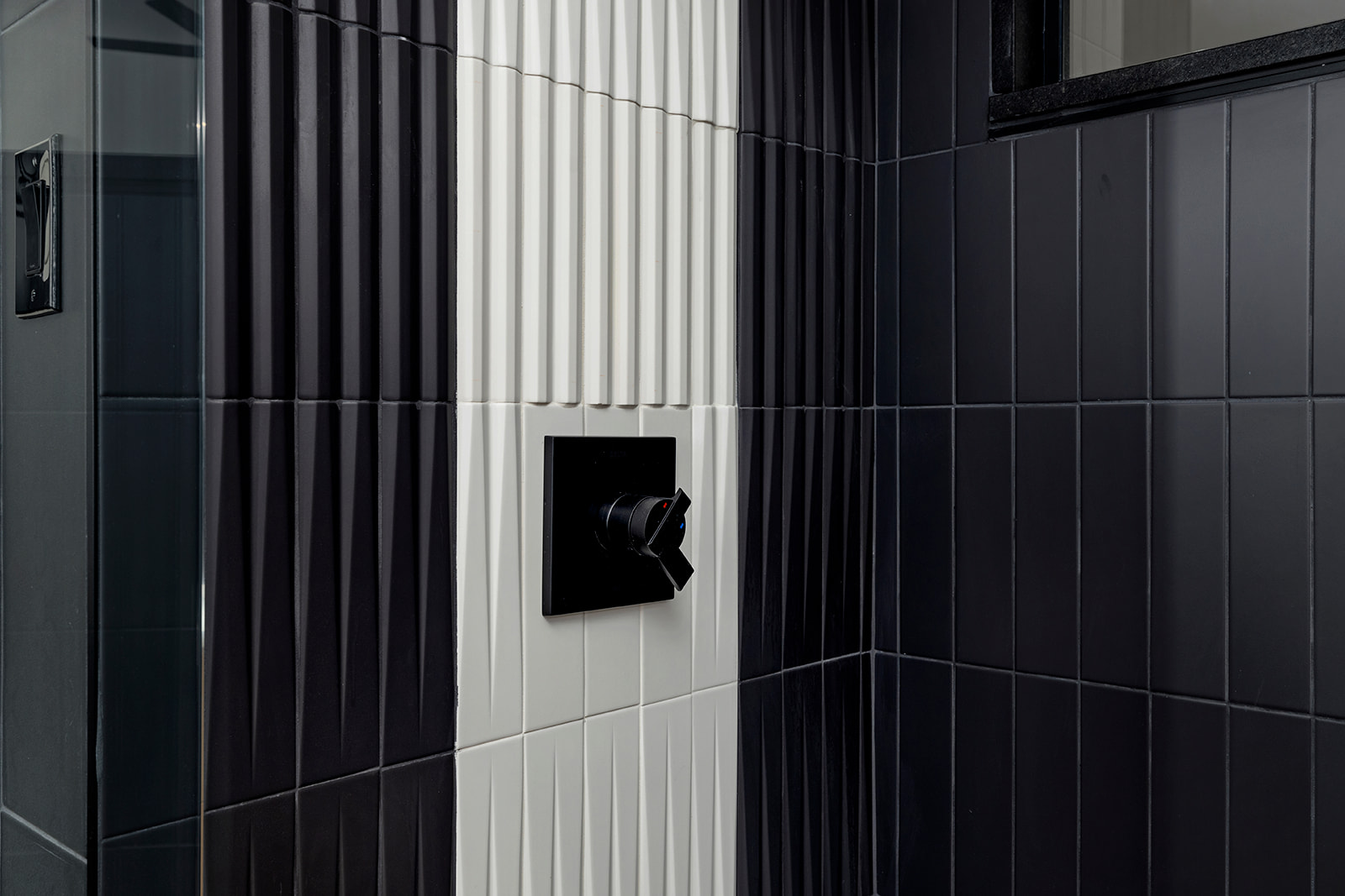 Shower with black tile and matte black fixtures