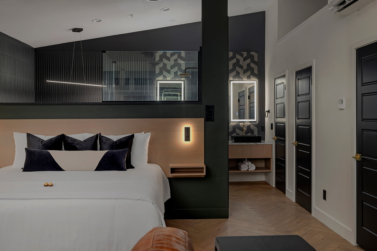 King bed with bathroom beyond in a Deckhouse Suite