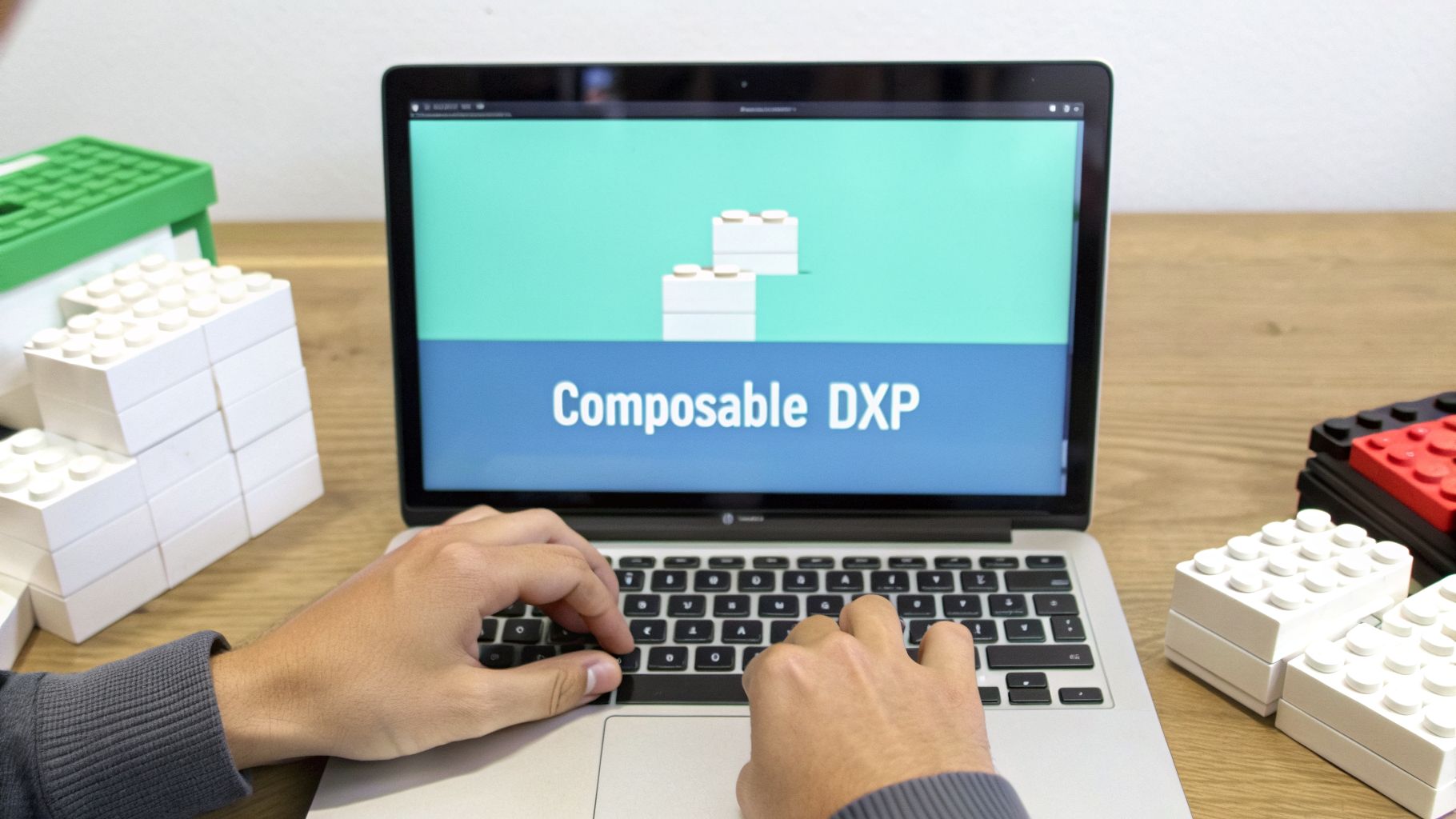 A person types on a laptop displaying 'Composable DXP' with Lego-like blocks, surrounded by toy blocks.