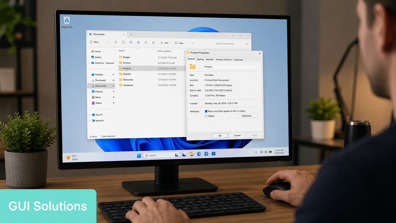 A person using a computer to view folder properties on a desktop screen in a home office.