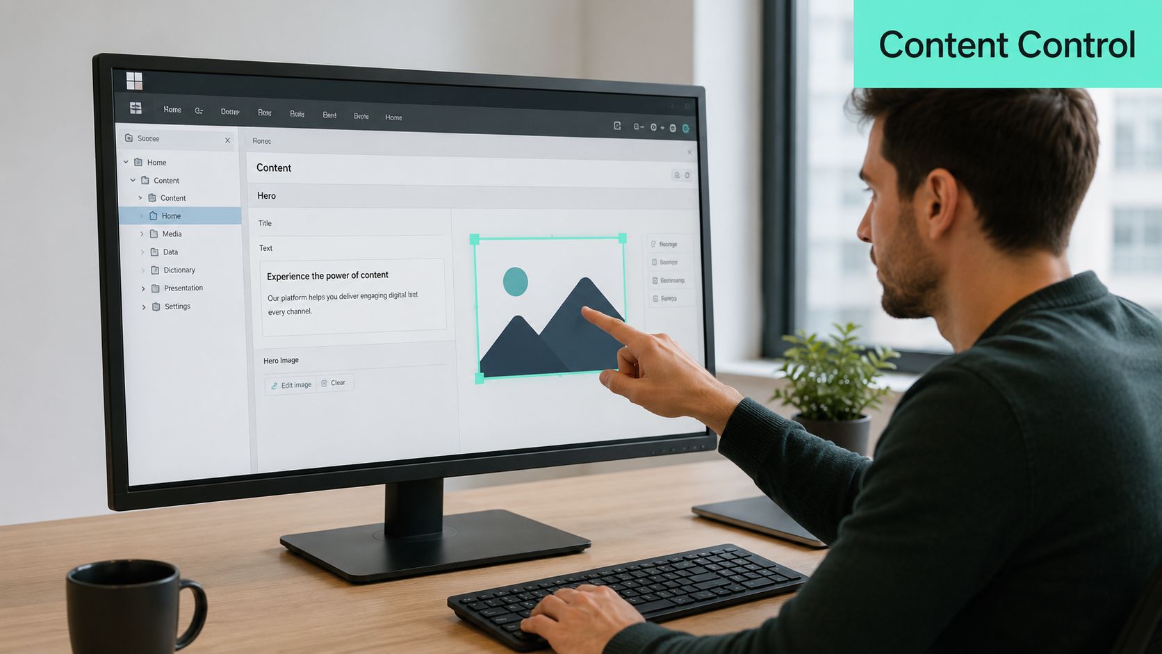 A man pointing at a computer monitor screen showing content management software interface for website hero design.