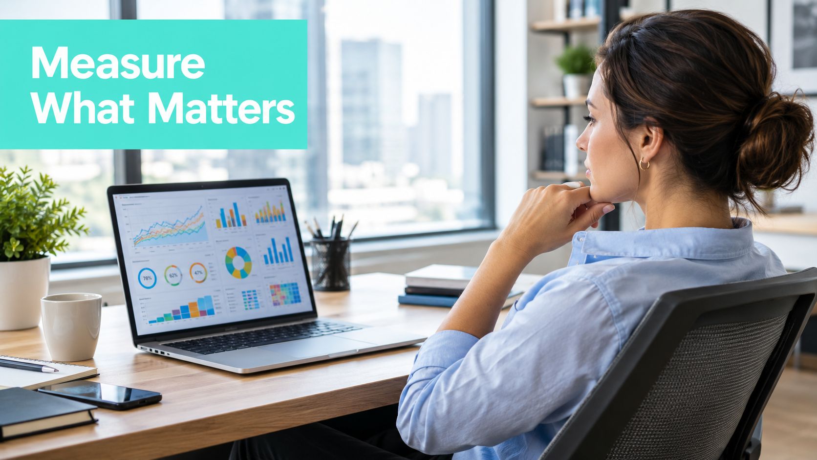 A professional woman viewing data analytics charts and graphs on a laptop screen in a bright office.