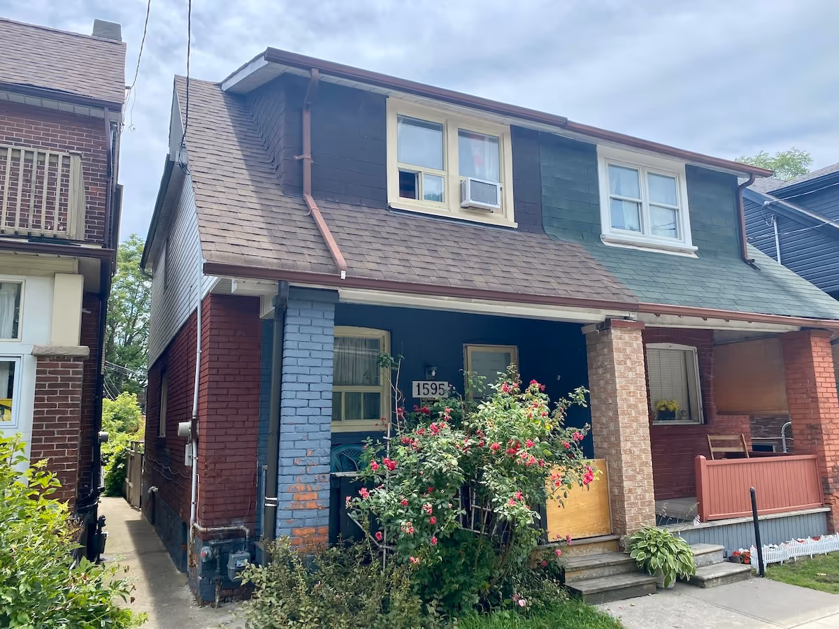 a second back view of the three story commercial building with parked vehicles in the adjacent parking lot.