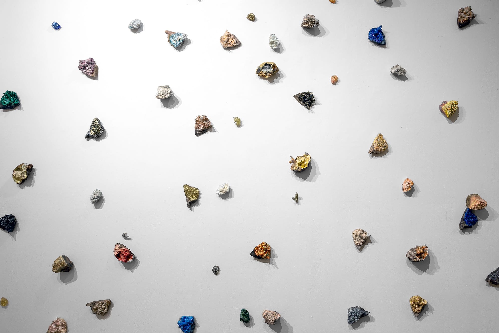 Crystal Finds Installation (78 crystals) (2022)<br>Hydrocal, molding paste, acrylic, ink, graphite, glass, enamel, glitter, resin; dims variable, each approx. 4 x 3 x 7”, installation 14 x 10