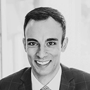 Headshot of a man in a suit smiling
