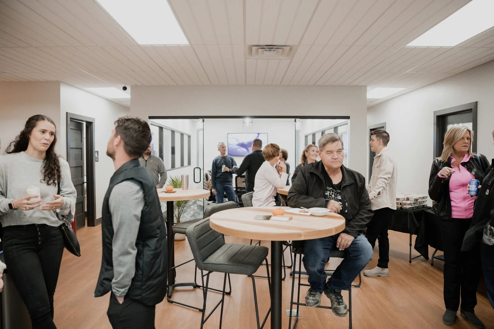 Professionals chatting in a shared kitchen area during a break - coworking benefits & productivity