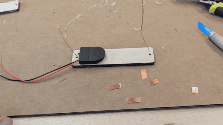 Glue the battery pack to the back of the plywood