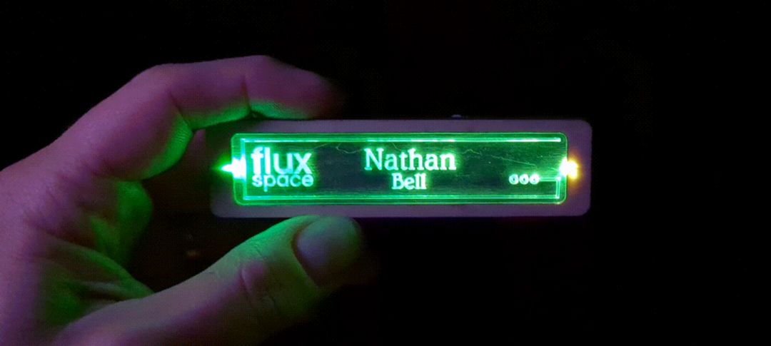 Laser cut name tag with green led shining through to make their name glow