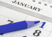 An image of a blue pencil sitting on a calendar marking January First